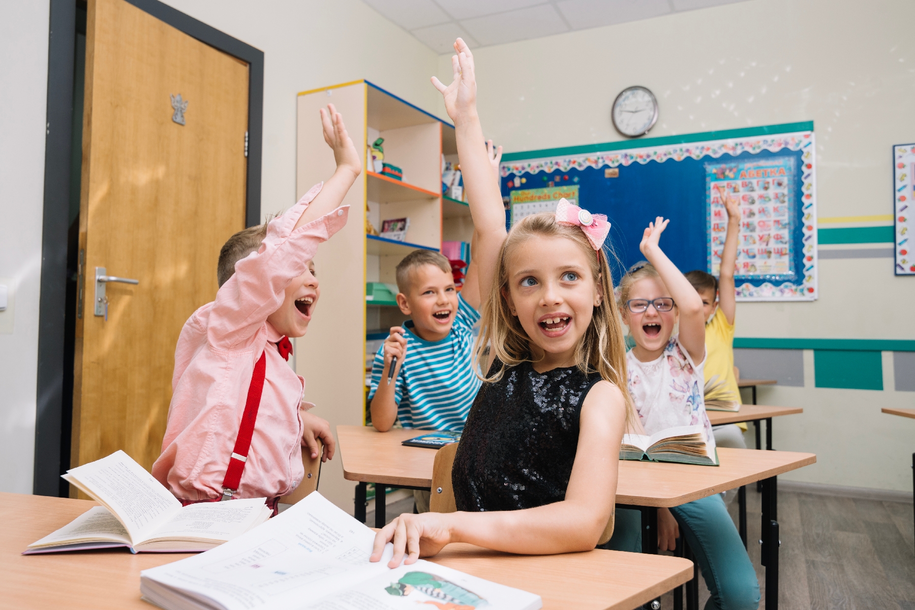 kids raising hands to get word