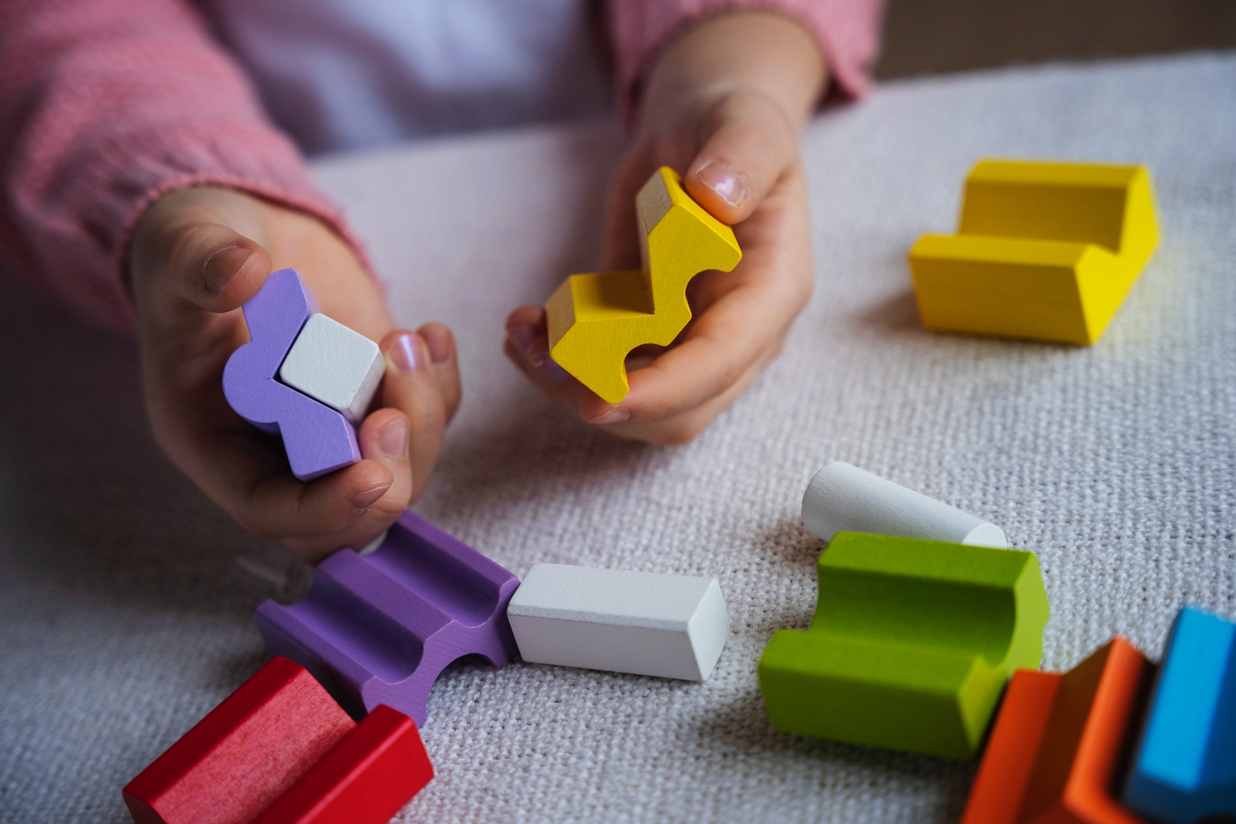 girl playing wooden memory game