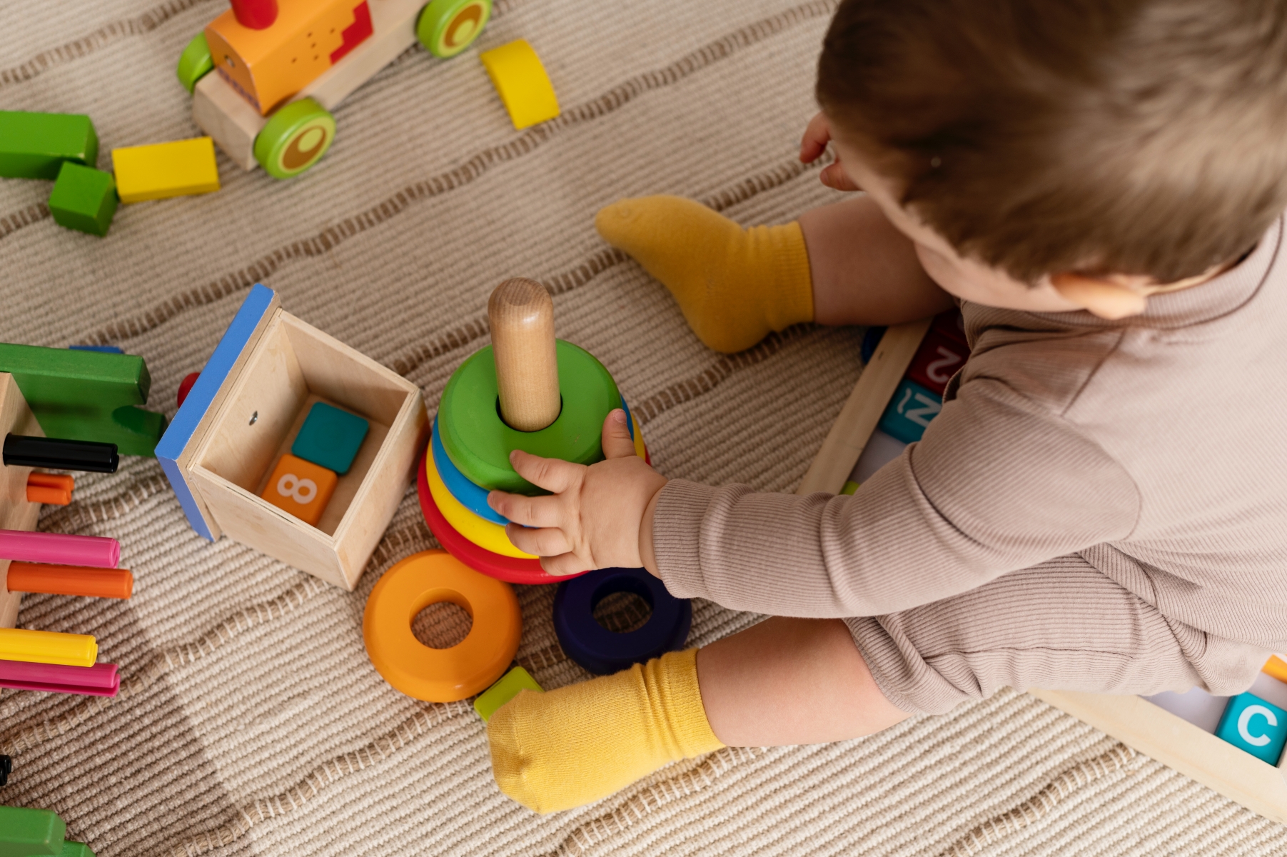 kid playing with colorful toys