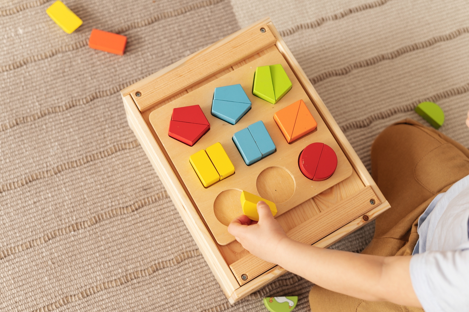 kid playing with wooden toys