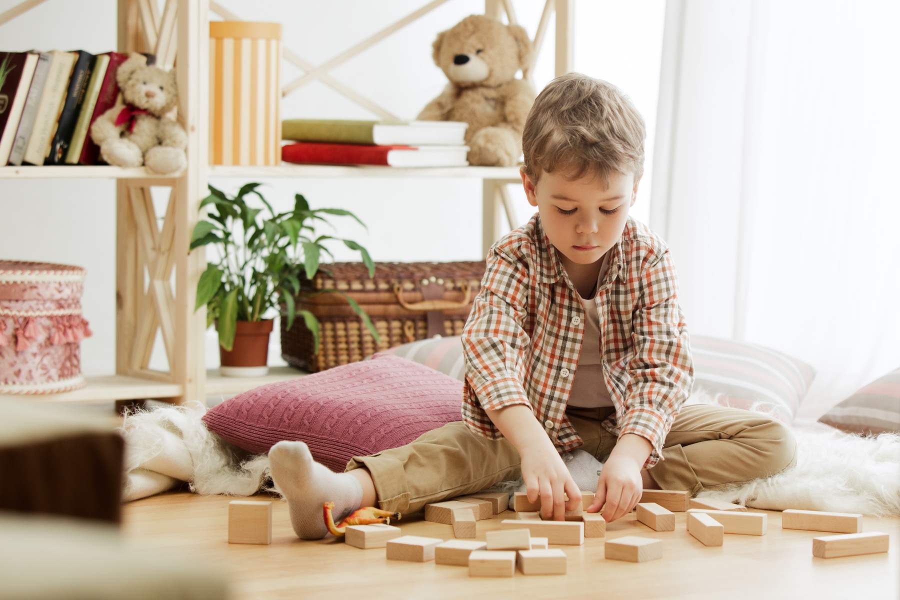 Kid playing with wooden toys